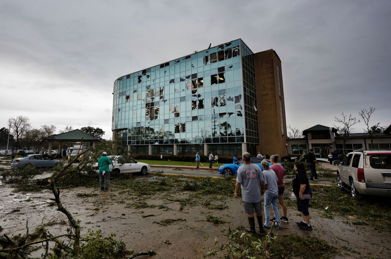 People survey <a href="https://www.cnn.com/2022/12/14/us/nationwide-massive-storm-tornadoes-wednesday/index.html" target="_blank">tornado damage</a> at the Iberia Medical Center in New Iberia, Louisiana, on Wednesday, December 14. 
