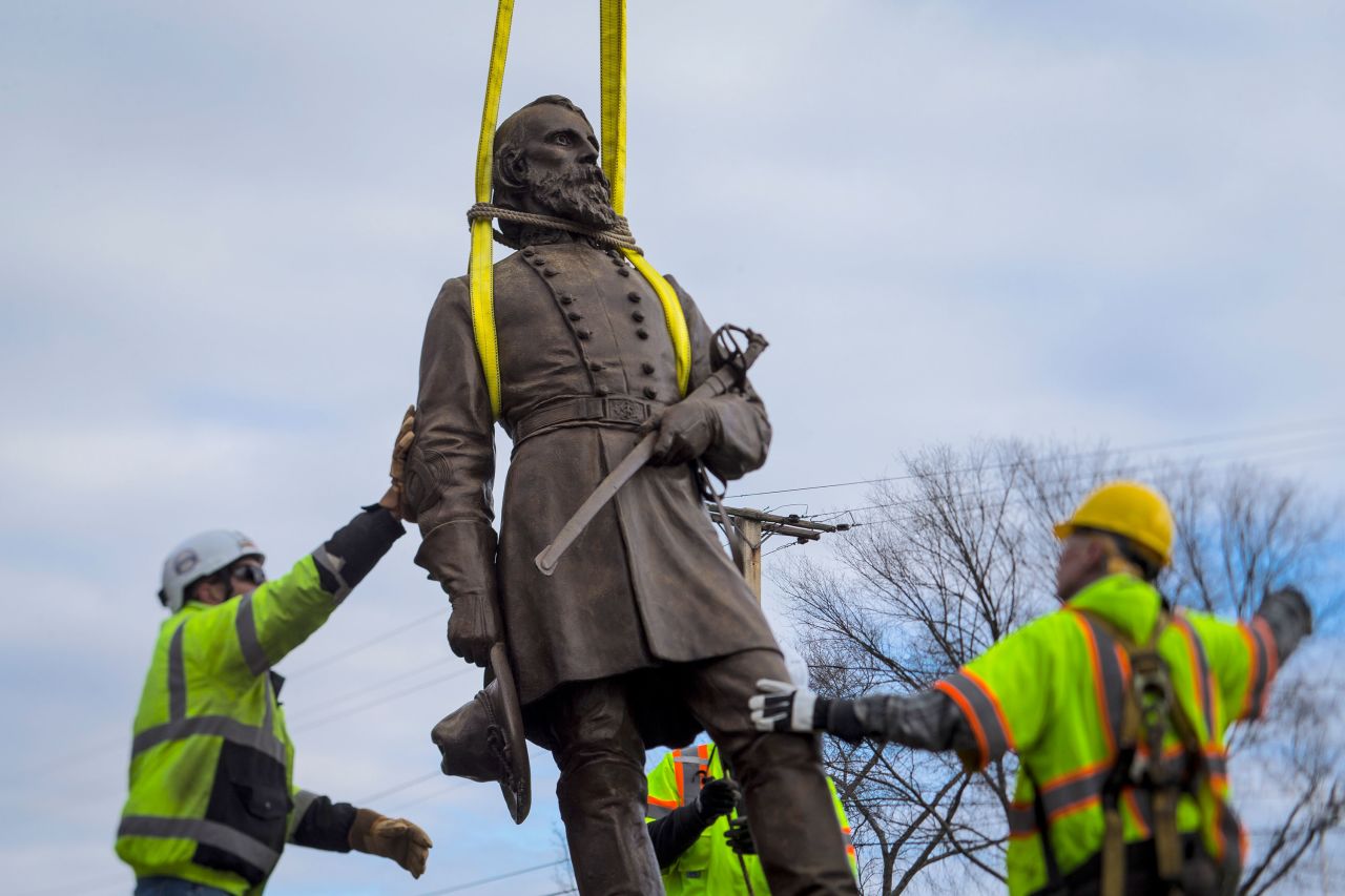 Workers begin to lay the bronze statue of Confederate Gen. A.P. Hill onto a flatbed truck in Richmond, Virginia, on Monday, December 12. The city was <a href="https://www.cnn.com/2022/12/12/us/richmond-virginia-confederate-statue-removal-reaj/index.html" target="_blank">removing its last standing Confederate monument</a>.
