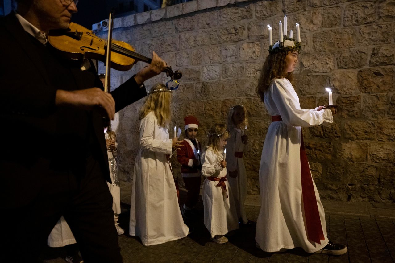 People in Jerusalem take part in a procession for St. Lucy's Day on Tuesday, December 13. The day commemorates Lucia of Syracuse, who in the fourth century delivered aid to persecuted Christians with a candlelit wreath atop her head.