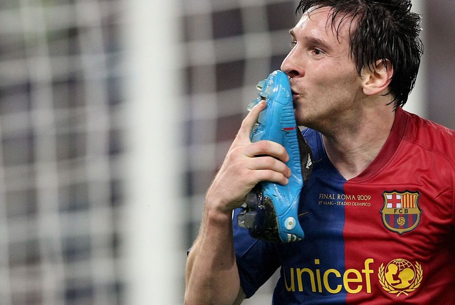 Messi kisses his boot after scoring his header against Manchester United. His boot had come off while landing on his jump.