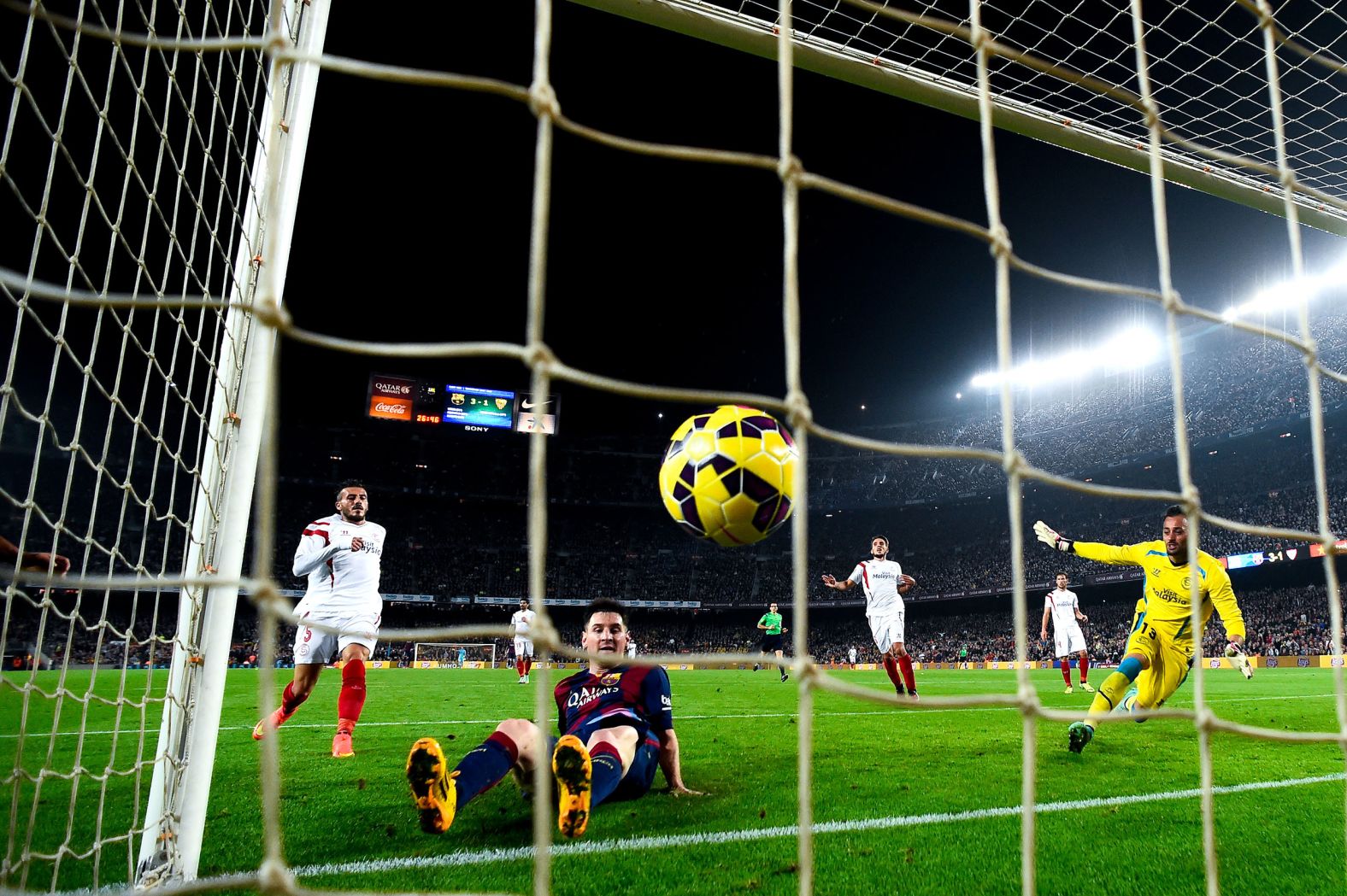 Messi scores a goal during a Spanish league match against Sevilla in November 2014. He had a hat trick and became the league's all-time leading goalscorer with 253 goals.