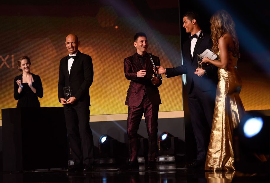 Messi takes the microphone from Ronaldo after they were selected for the FIFA World XI in 2015.