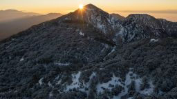 ANGELES NATIONAL FOREST, CA - DECEMBER 13: In an aerial view, cloudless weather at sunrise in the snow-covered San Gabriel Mountains is seen as a massive storm leaves California to spread across the nation on December 13, 2022 in the Angeles National Forest, near Los Angeles, California. The storm system, which brought heavy snow and winds up to 169 miles per hour in the Sierra Nevada Mountains, is predicted to cause blizzards in the northern states, severe weather in the South and a noreaster on the East coast.