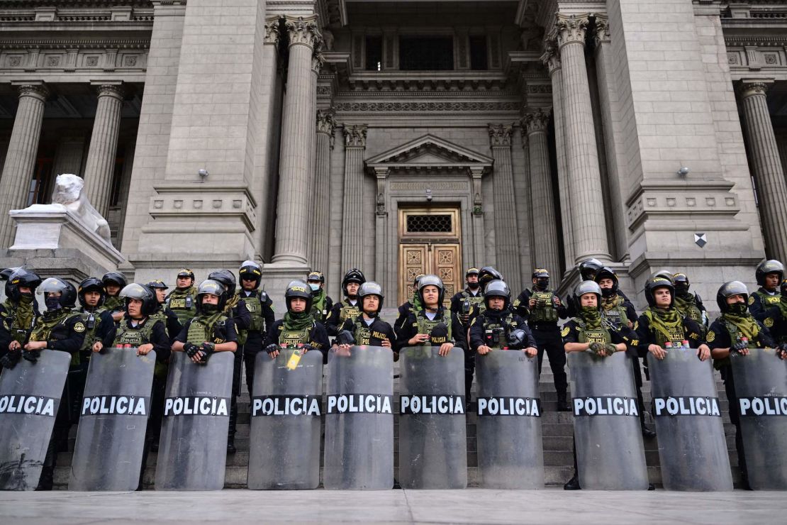 Police guard the Justice Palace in Lima, on December 15, 2022, during a nationwide state of emergency. 