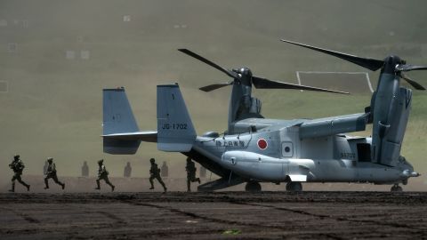 Members of the Japan Ground Self-Defense Force disembark from a V-22 Osprey aircraft during a live fire exercise at East Fuji Maneuver Area on May 28, 2022.