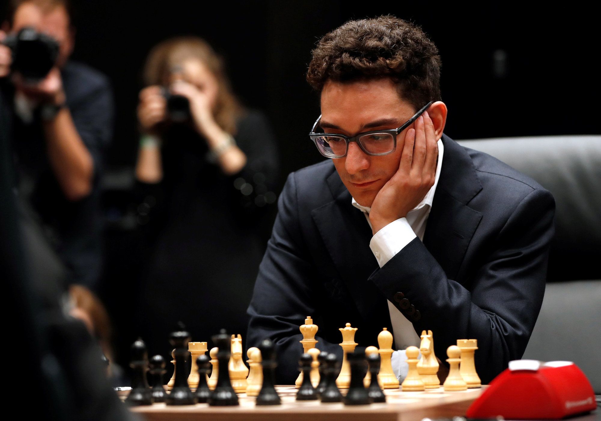 Reigning chess world champion Magnus Carlsen, right, from Norway, plays  Italian-American challenger Fabiano Caruana in the first five minutes of  round three of their World Chess Championship Match in London, Monday, Nov.