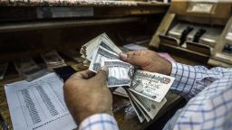 A man counts Egyptian pounds at a currency exchange shop in downtown Cairo in 2016. 