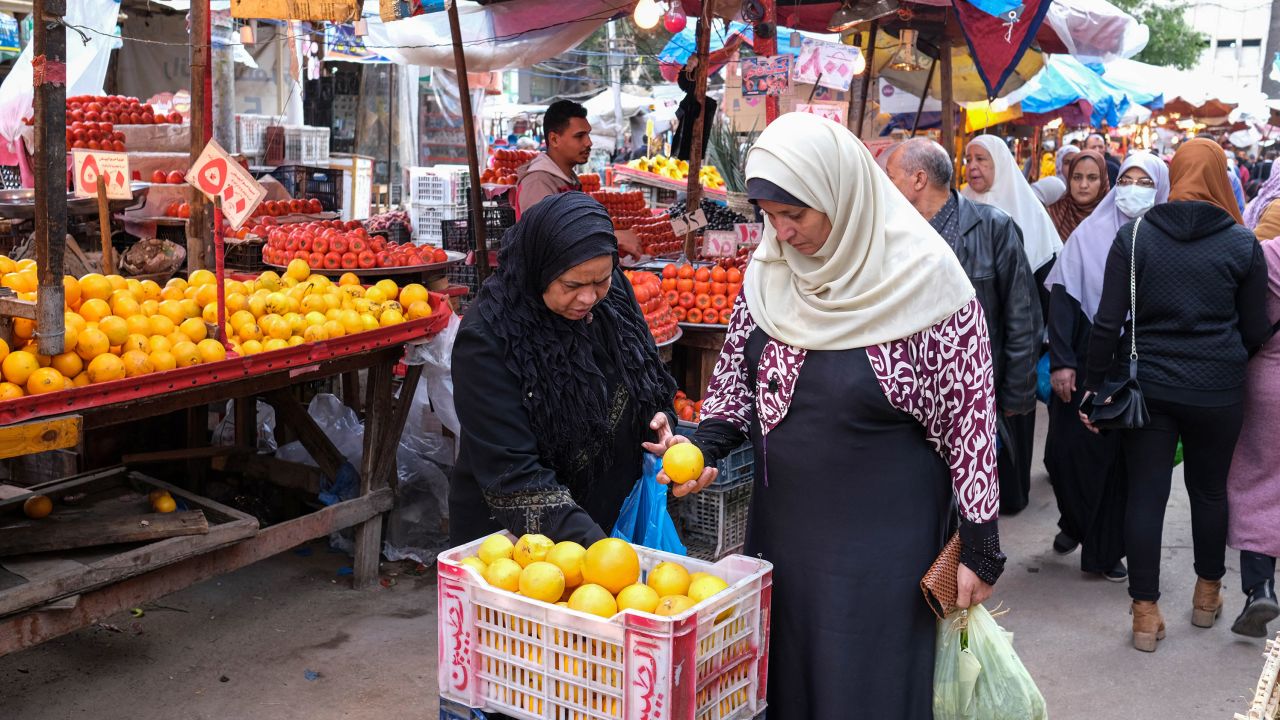 Shoppers browse fresh fruit for sale at a market in Alexandria, Egypt.