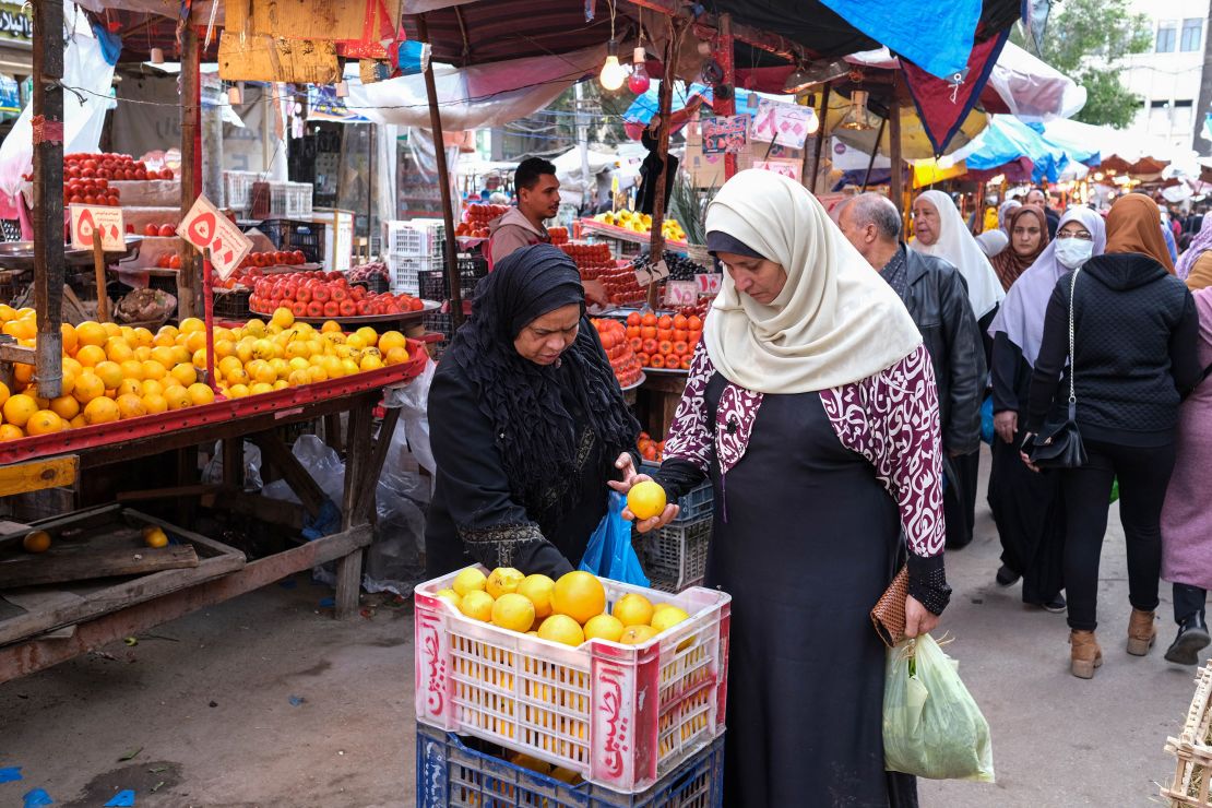 Shoppers browse fresh fruit for sale at a market in Alexandria, Egypt.
