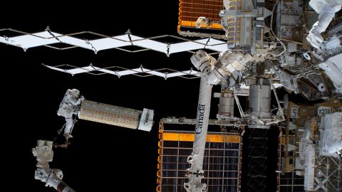 NASA astronaut Josh Cassada holds a mobile solar array during installation outside the International Space Station on Dec. 3.