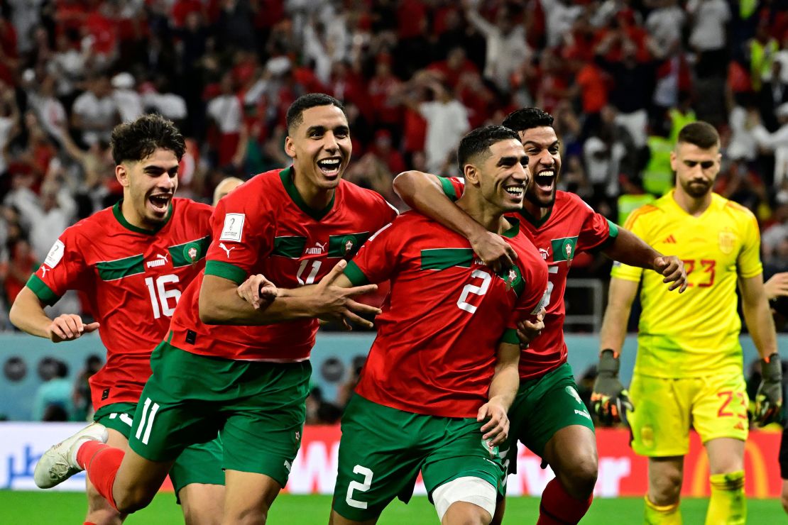 Morocco's Achraf Hakim celebrates with teammates after converting the last penalty during the penalty shoot-out against Spain.
