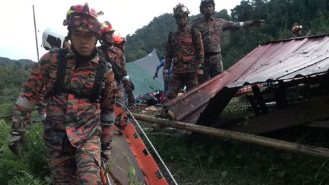 Rescuers appear at the camp on Friday