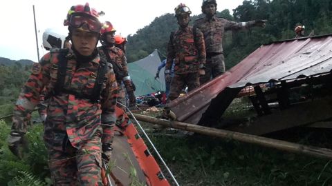 Rescuers workers are seen at the campsite on Friday