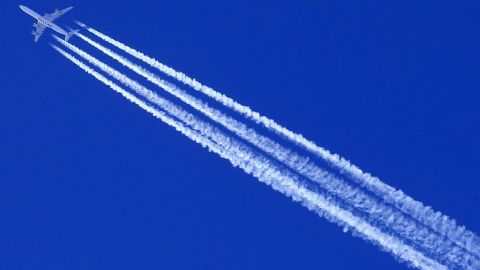 A Qatar Airways Airbus A340 plane leaves contrails in the sky.
