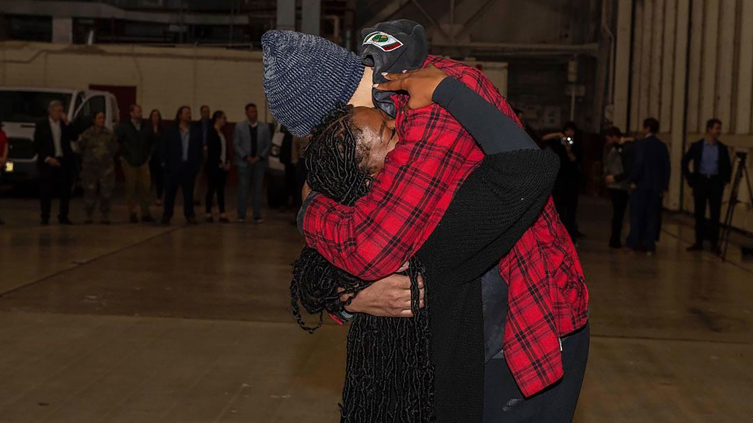 Griner hugs her wife, Cherelle, after landing in San Antonio.