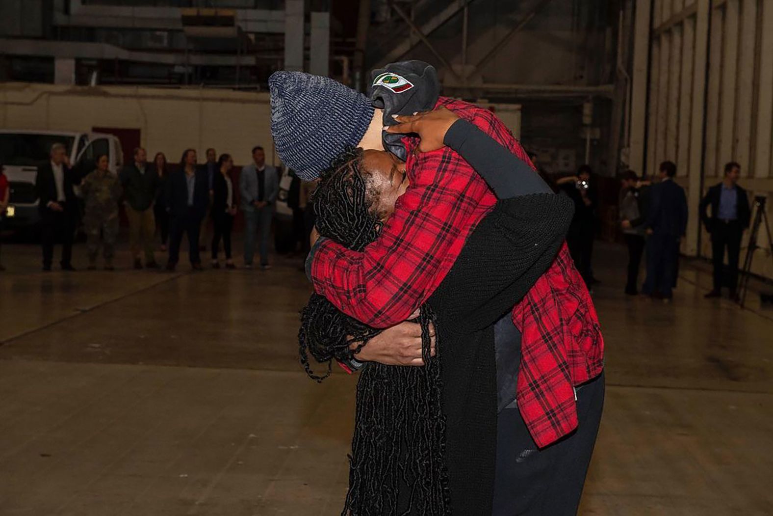 Griner hugs her wife, Cherelle, after landing in San Antonio.