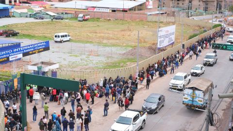 Travelers wait outside Cusco airport on Friday after it was temporarily closed due to protests.