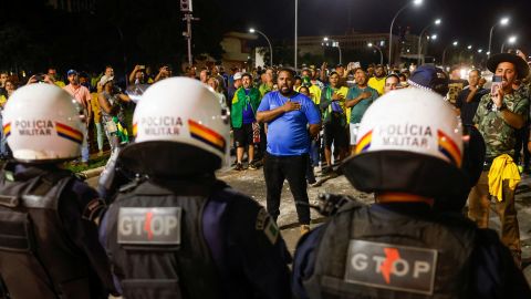 Police officers stand guard during a protest in Brasilia, on December 12.