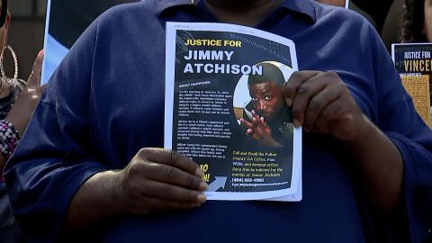 Jimmy Atchison's father, Jimmy Hill, holds a flyer with his son's photo.