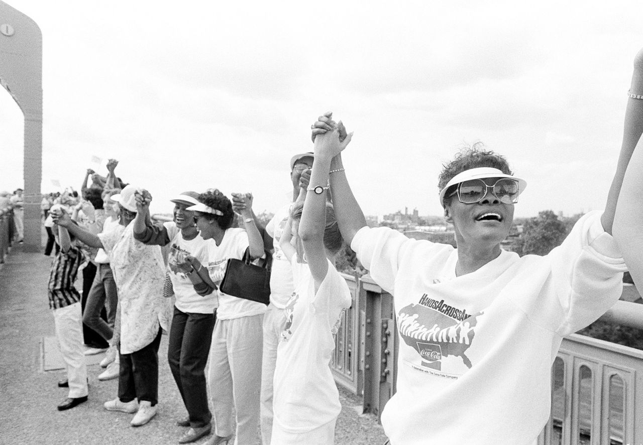 Warwick, right, joins the Hands Across America fundraising event on the Benjamin Franklin Bridge in Camden, New Jersey, in May 1986.