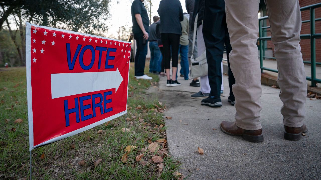 People wait in line to vote at a polling place in Fuquay-Varina, North Carolina, on November 8, 2022. 