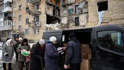 Residents of Gorenka village, Kyiv region, receive humanitarian aid on December 13, 2022 anid Russian invasion of Ukraine. (Photo by SERGEI CHUZAVKOV / AFP) (Photo by SERGEI CHUZAVKOV/AFP via Getty Images)