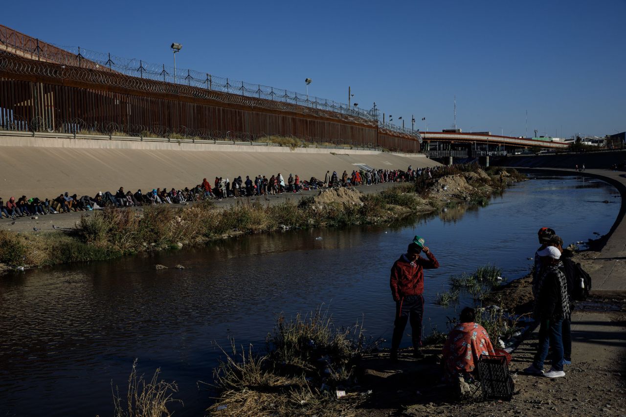 Migrants wait in line to be taken in by US Border Patrol on December 15.