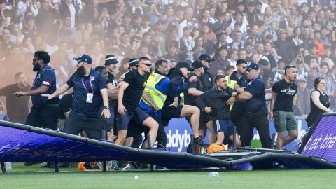 Fans invade the pitch during the game between Melbourne City and Melbourne Victory.