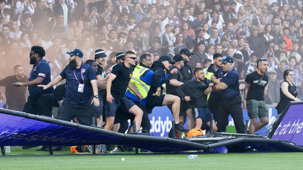 Fans invade the pitch during the game between Melbourne City and Melbourne Victory.