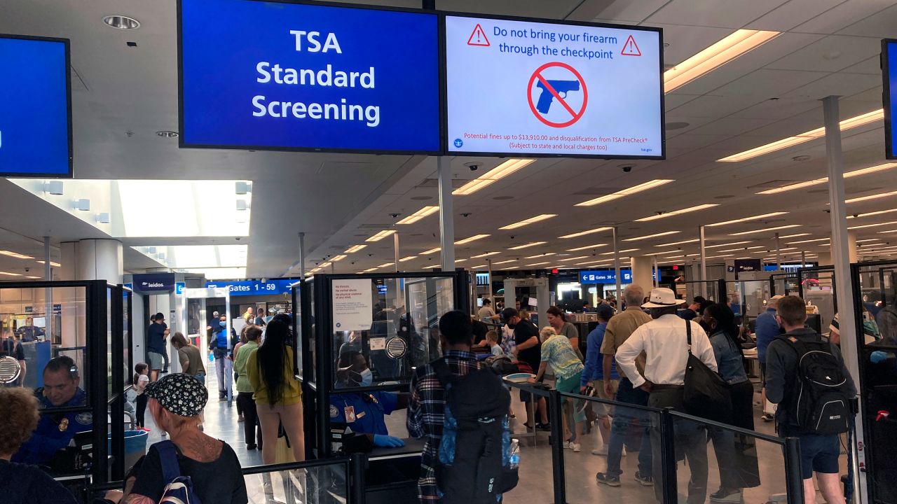 A sign warns travelers not to bring guns through a TSA checkpoint at Florida's Orlando International Airport in April.
