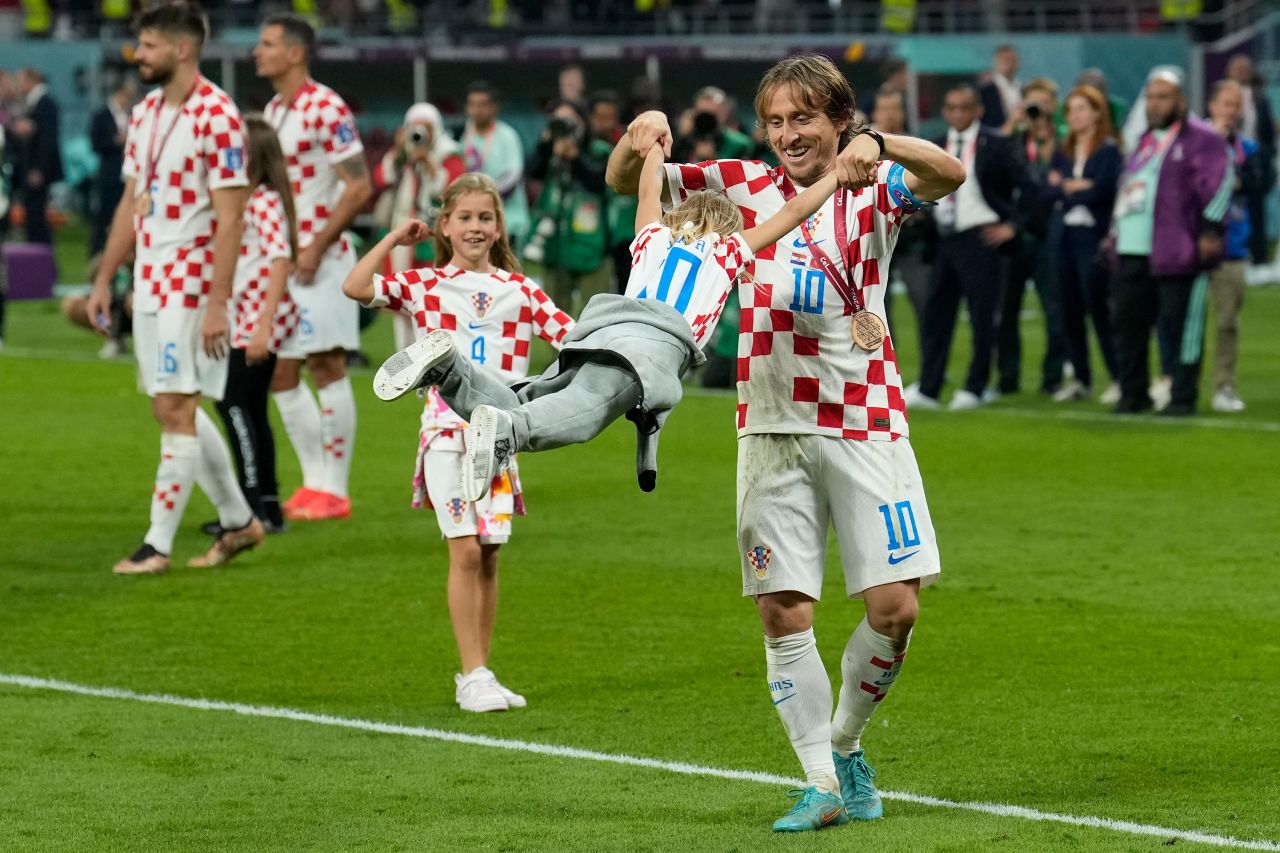 Croatia captain Luka Modrić celebrates with his daughter after the medal ceremony on Saturday. 