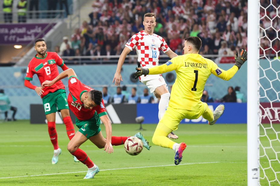 Morocco's Achraf Dari scores a header to tie the match against Croatia. Croatia ultimately regained the lead with a goal from Mislav Oršić.