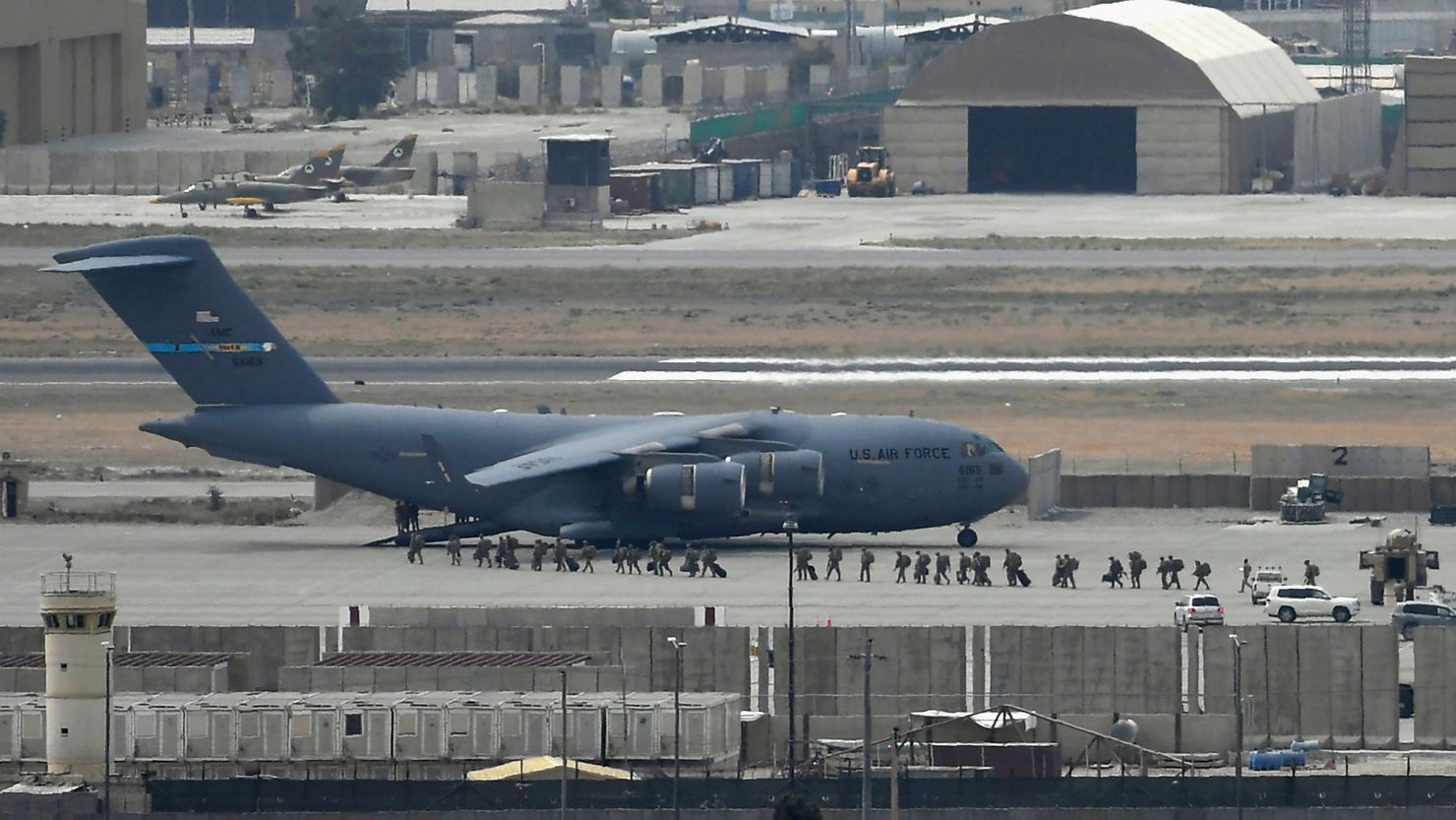 US soldiers board an US Air Force aircraft at the airport in Kabul on August 30, 2021.