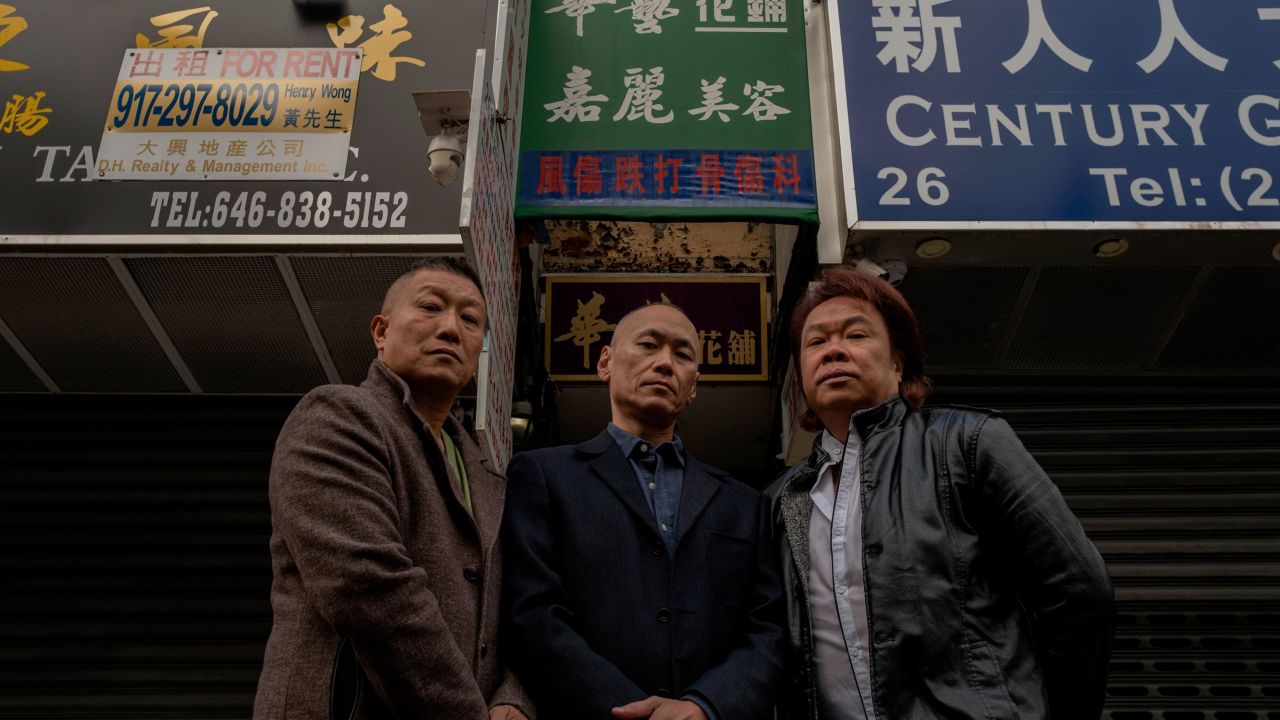 From left to right, Kenny Wong, Mike Moy and Jimmy "Bighead" Tsui stand in front of Moy's childhood home in Manhattan's Chinatown, New York City, on December 17. 