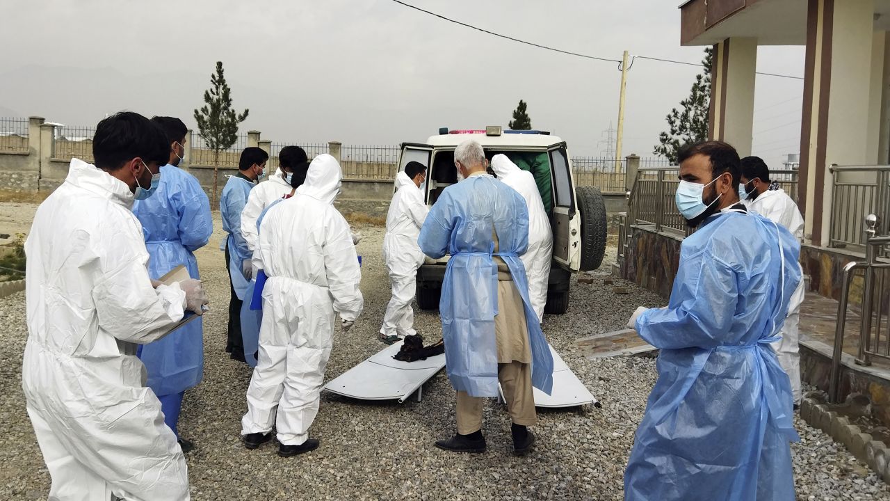 Medical workers collect the bodies of victims of a fuel tanker fire in the Salang Tunnel through the Hindu Kush mountains north of Kabul, Afghanistan, on December 18, 2022.