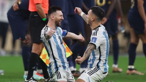 Lionel Messi and Leandro Paredes celebrate after winning the penalty shootout.