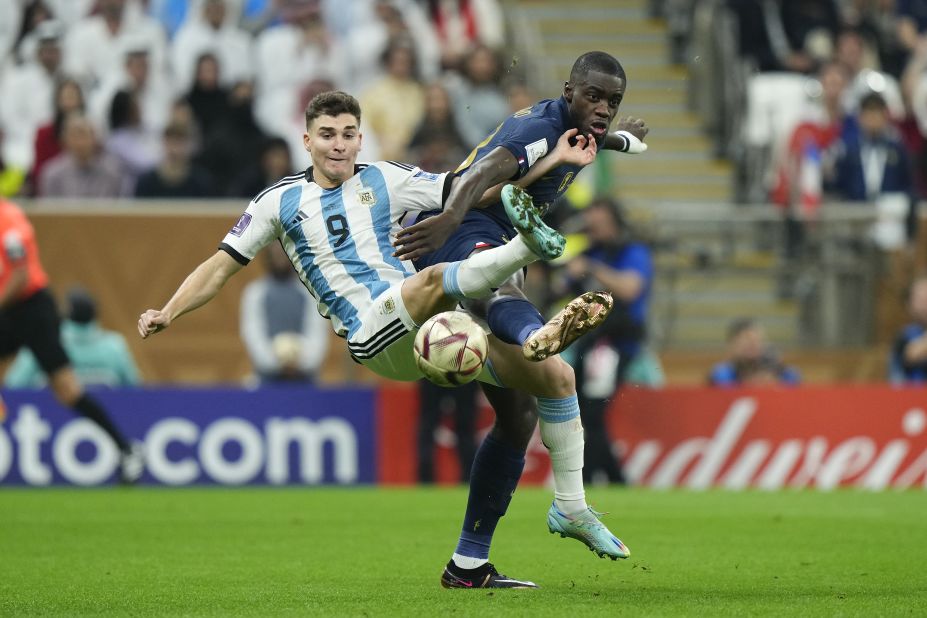 Argentina's Julián Álvarez, left, competes with France's Dayot Upamecano.