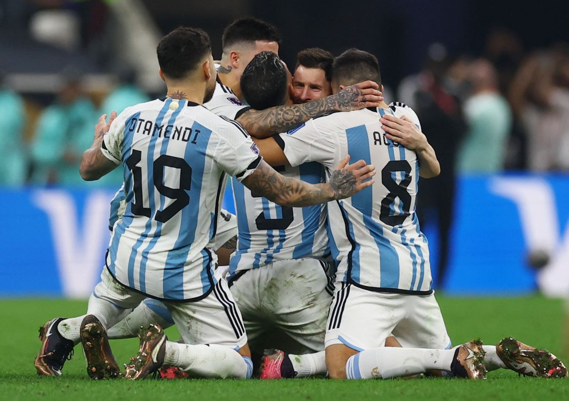 Messi's teammates join him in celebrating.