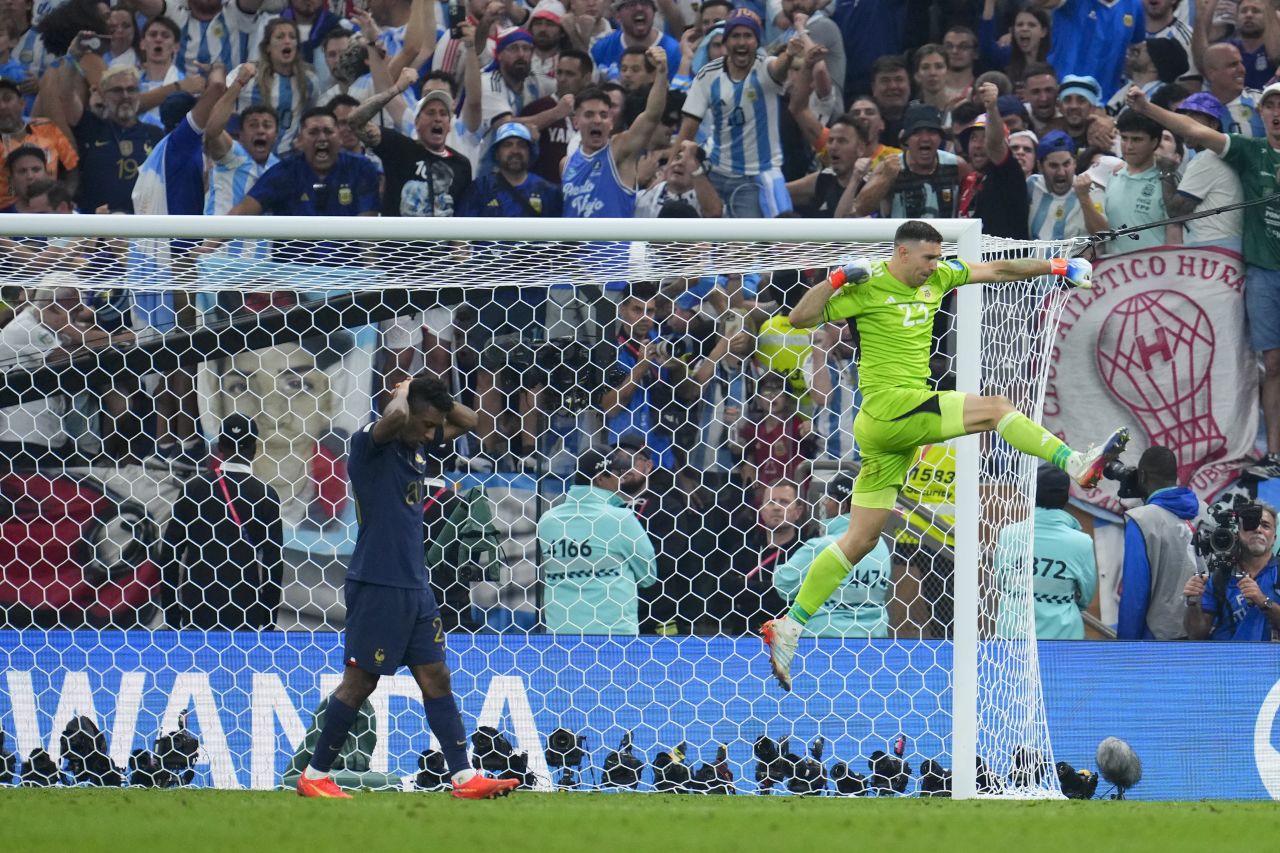 Argentina goalkeeper Emiliano Martinez celebrates after blocking Kingsley Coman's penalty in the shootout.