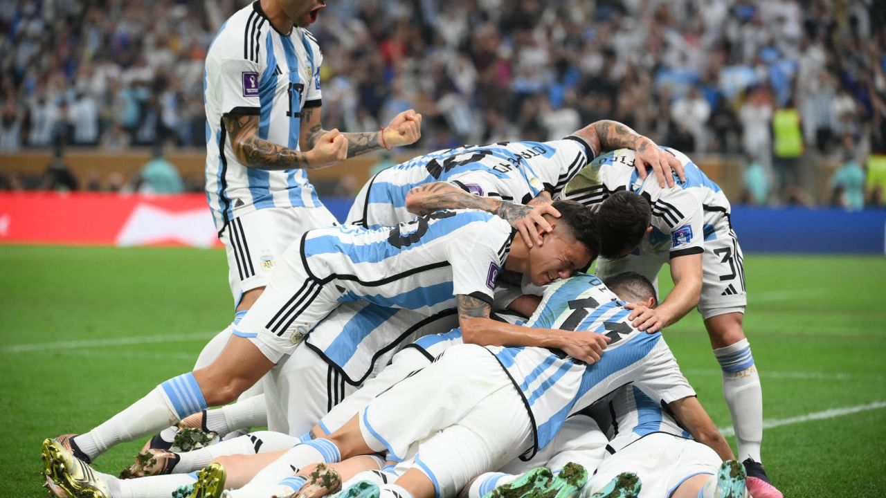 Messi's teammates celebrate with him after scoring the opening goal.