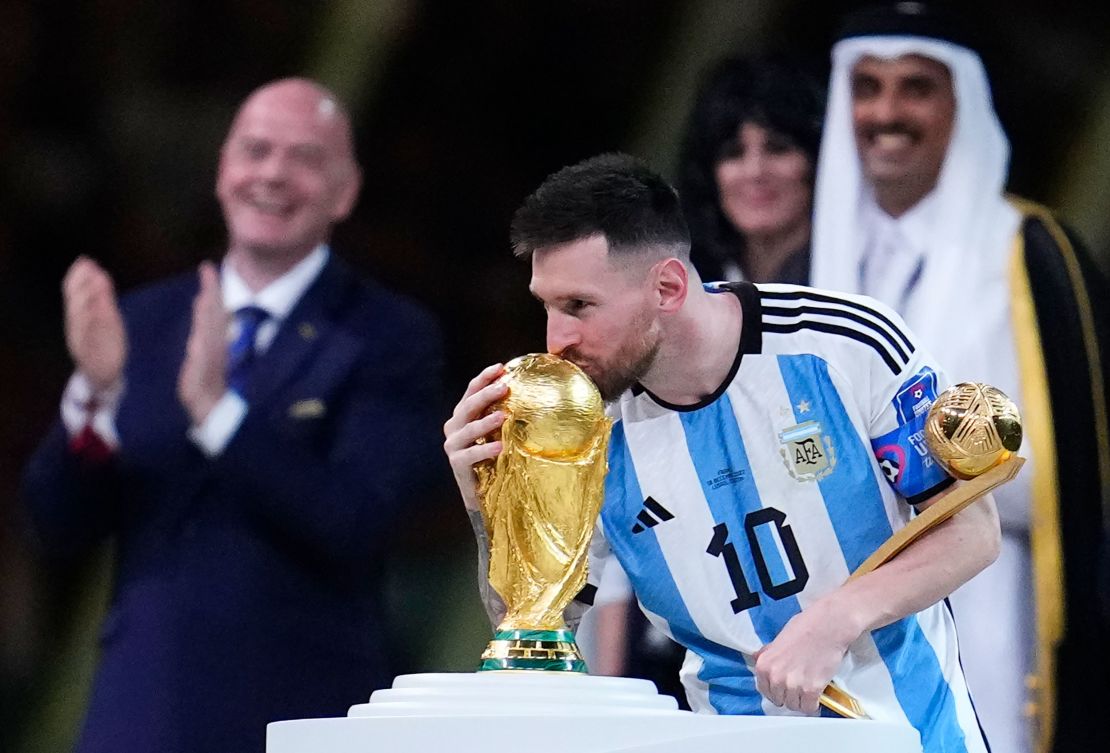 Lionel Messi kisses the World Cup trophy after receiving the Golden Ball award for best player of the tournament.