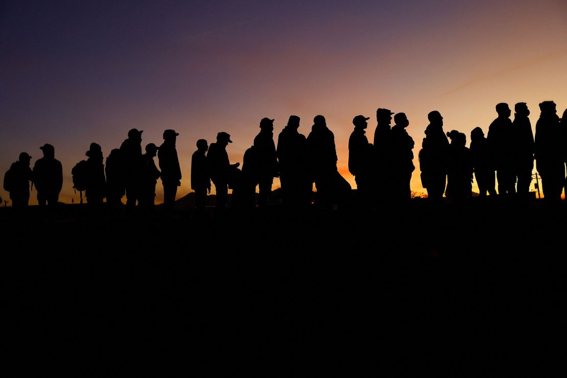 Venezuelan migrants stand near the Rio Bravo river, the border between Mexico and the US, as they wait for the announcement about the end of Title 42 on December 21, in Ciudad Juarez.