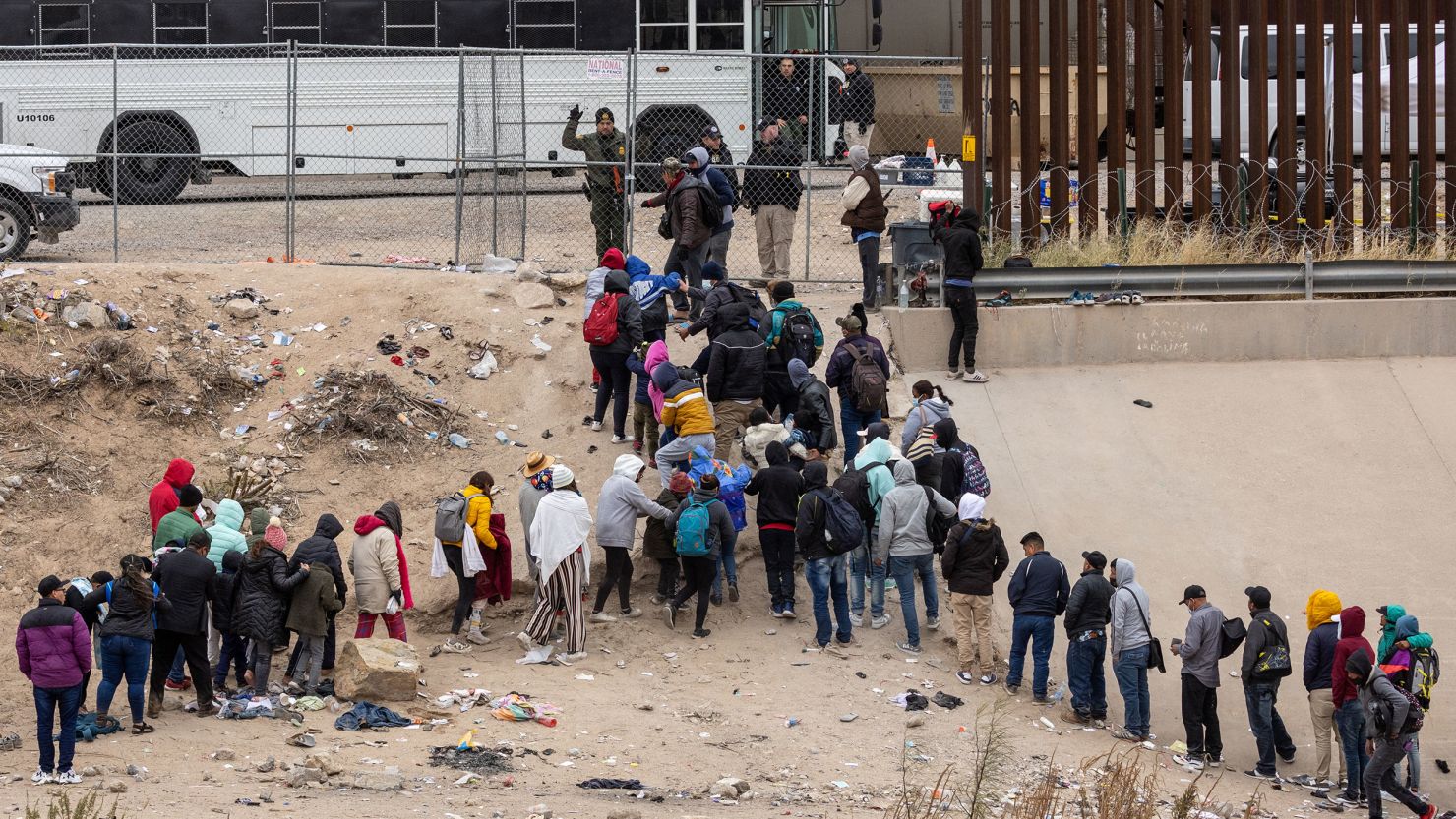 Immigrants seeking asylum turn themselves in to US Border Patrol agents after wading across the Rio Grande to El Paso, Texas, on December 18, 2022.