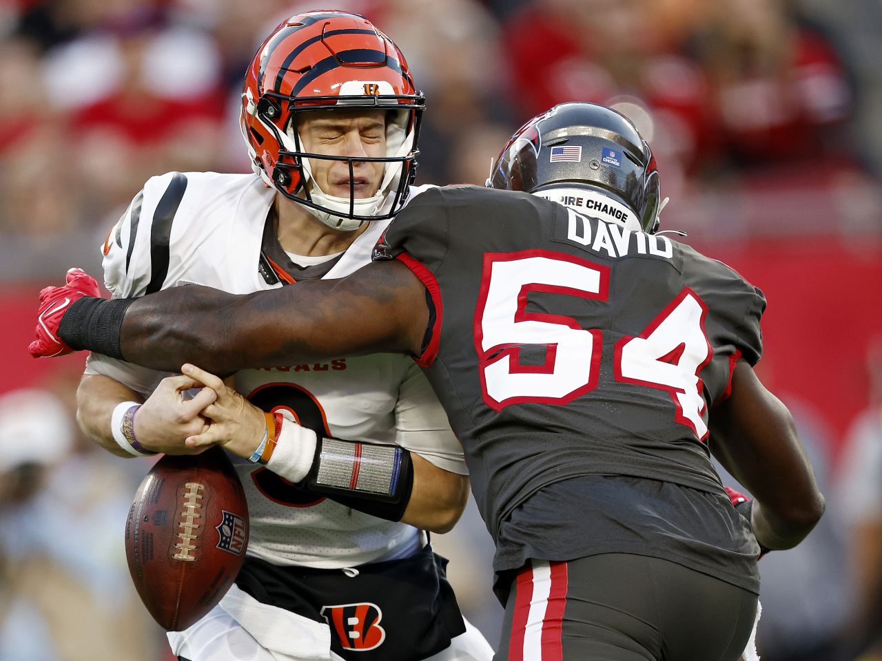 Joe Burrow of the Cincinnati Bengals is sacked by Lavonte David of the Tampa Bay Buccaneers at Raymond James Stadium in Tampa Bay, Florida, on Sunday, December 18.