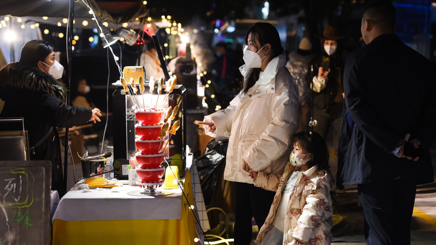 Residents purchase snacks at a night market in Chongqing, China, on December 14.