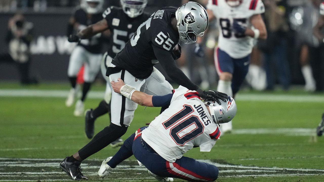 Jones breaks a tackle by New England Patriots quarterback Mac Jones to score a touchdown. 