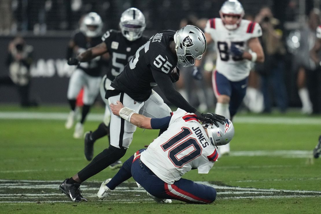 Jones breaks a tackle by New England Patriots quarterback Mac Jones to score a touchdown. 