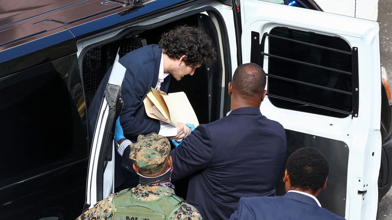 Sam Bankman-Fried, the founder and former CEO of crypto currency exchange FTX, is escorted into the Magistrate Court building in Nassau, Bahamas December 19, 2022.