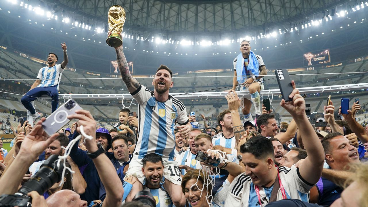 LUSAIL, QATAR - DECEMBER 18: Argentina forward Lionel Messi (10) holds aloft the World Cup trophy after defeating France to win the final match of the FIFA World Cup 2022 between Argentina and France at Lusail Stadium in Lusail, Qatar on December 18, 2022. (Photo by Jabin Botsford/The Washington Post via Getty Images)