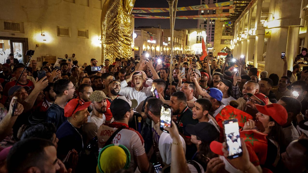 Supporters dance and sing at the Souq Waqif in Doha on November 30, 2022, during the Qatar 2022 World Cup football tournament.
